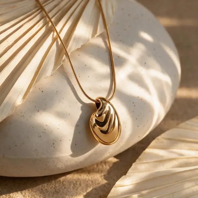 Gold-Plated Pebble Pendant Necklace: Meaning & Care